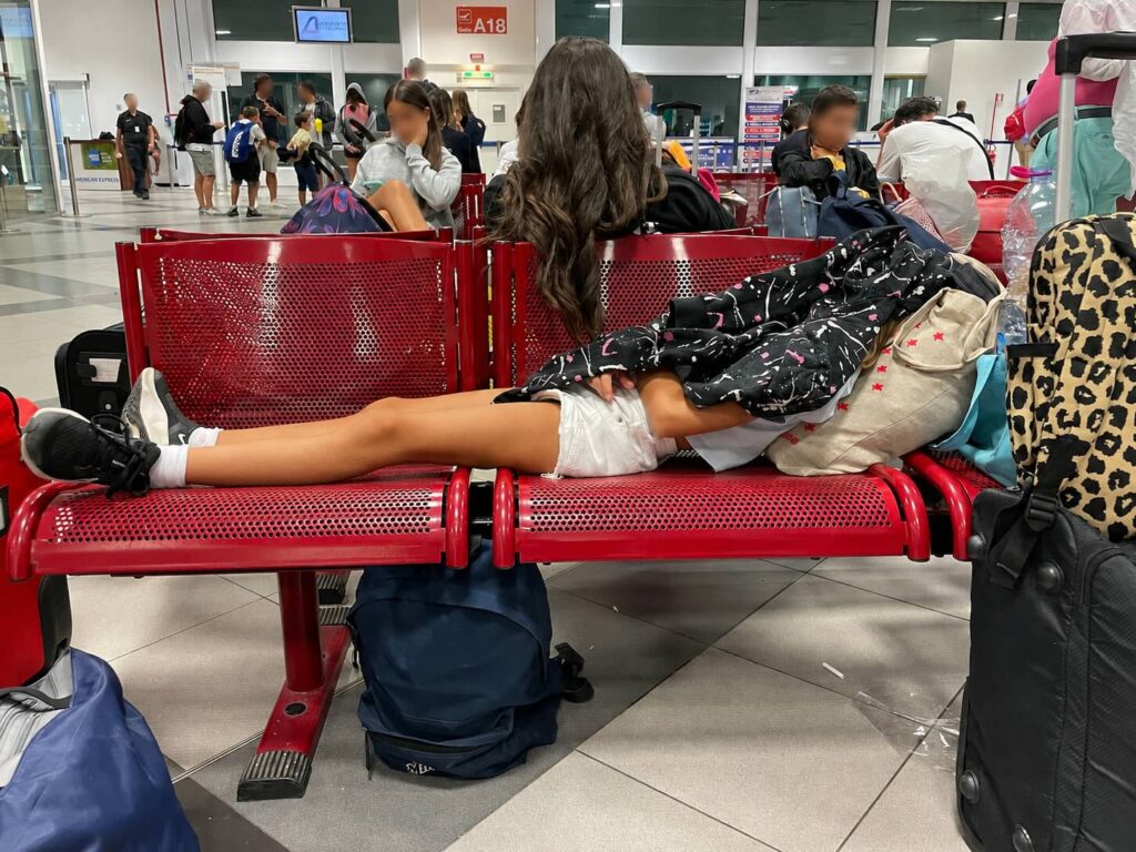 Ritardi aerei e voli per la Sicilia: cosa sapere sui rimborsi UE 1 Passeggeri in attesa in aeroporto con bagagli, immagine illustrativa per un articolo sui ritardi aerei e i rimborsi UE per i voli da e per la Sicilia.